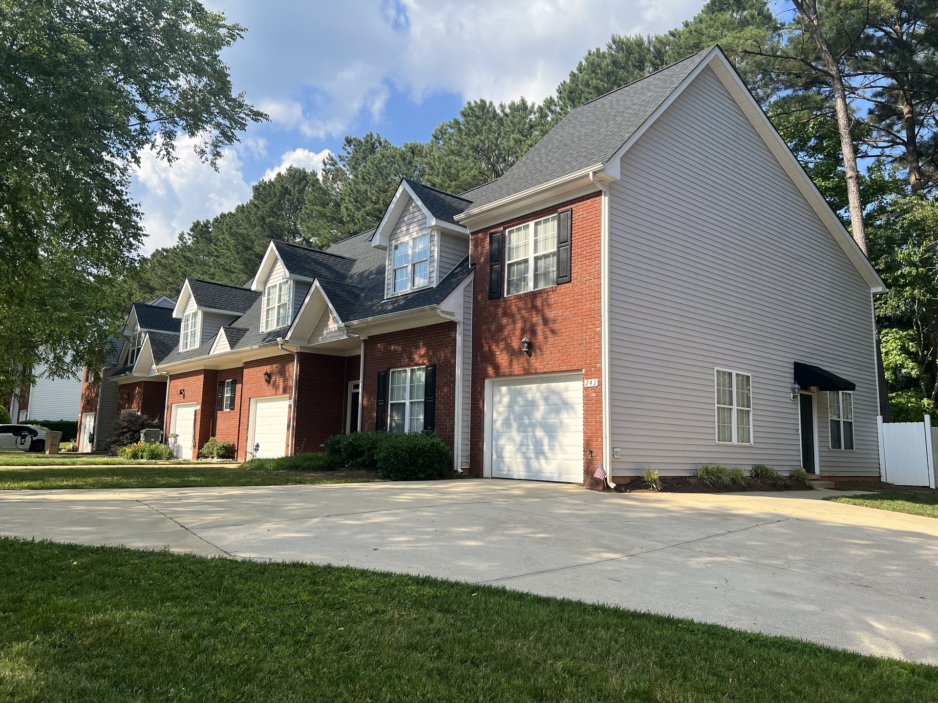 Street view of a two-story home's roof published in Sunset Roofing and Construction's project gallery