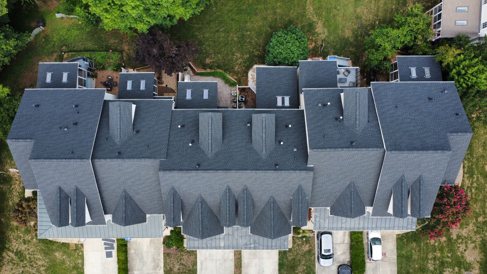 Aerial view of a multi-family townhome community with new shingle roofs